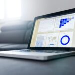 Sleek laptop showcasing data analytics and graphs on the screen in a bright room.